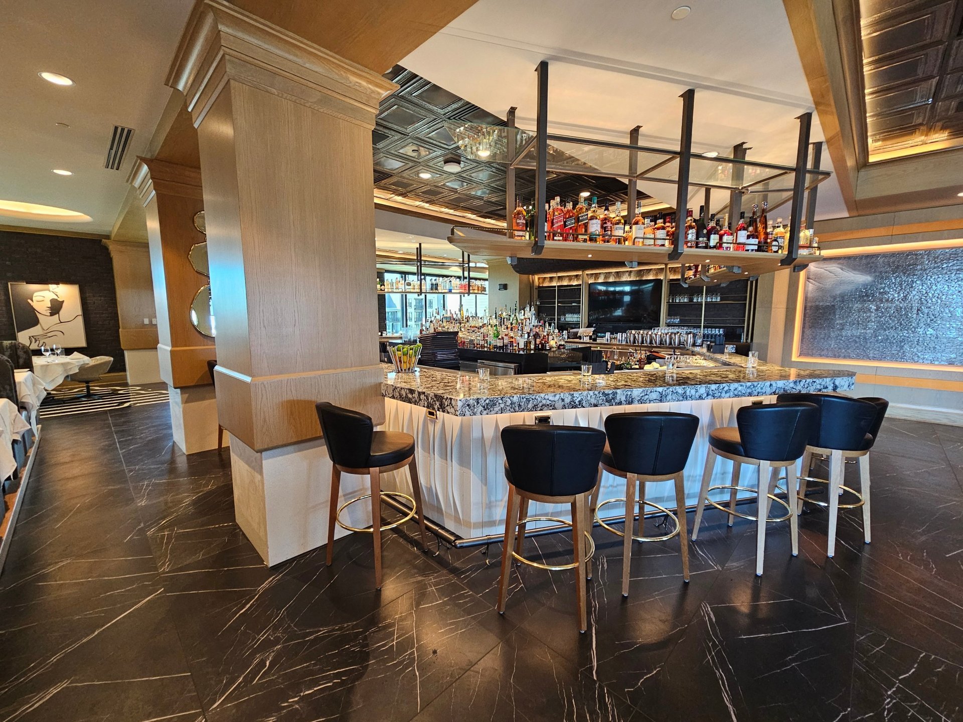 Ruth's Chris island bar — marble countertop, fluted millwork front and bar seating from entry