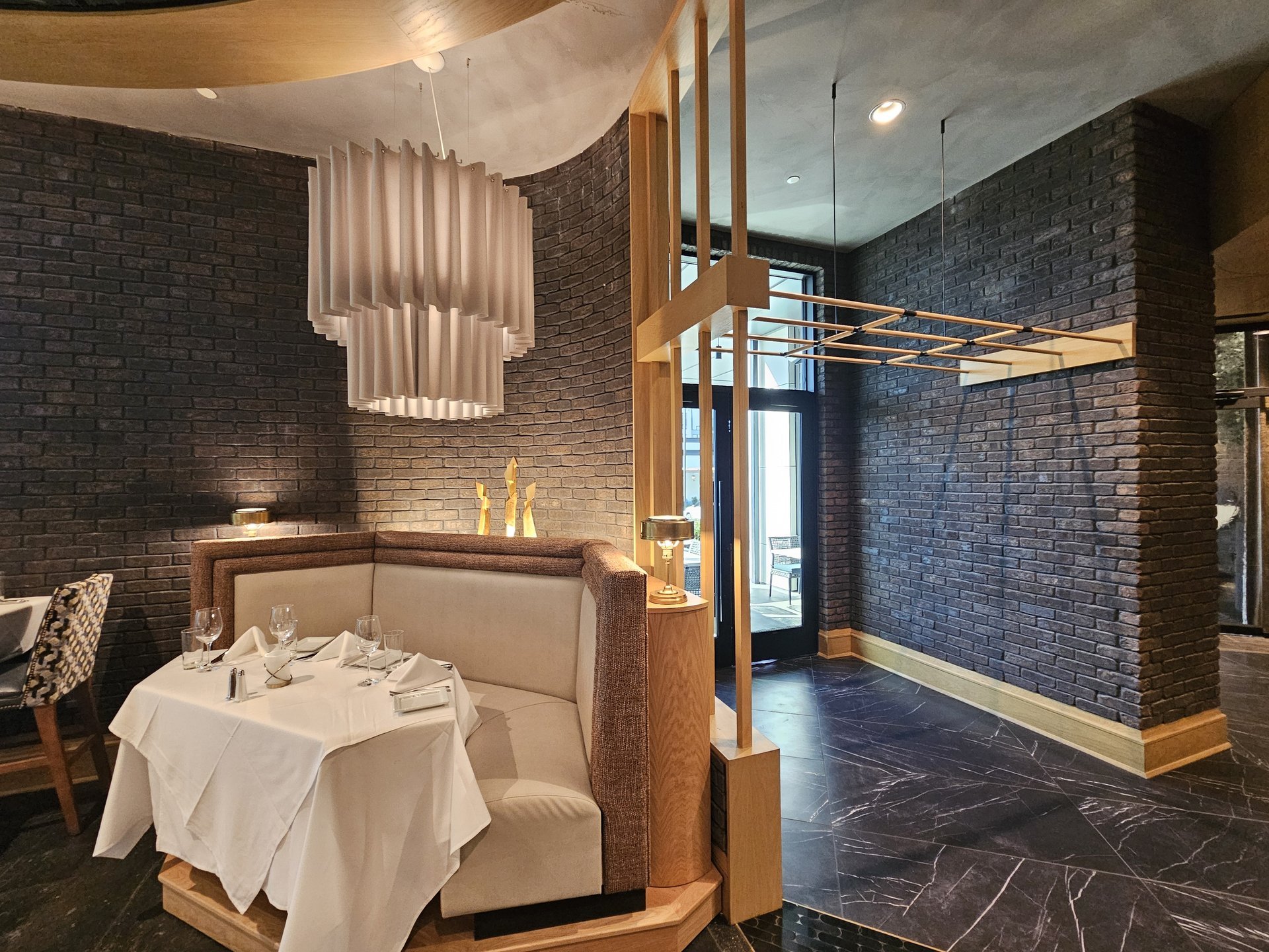 Ruth’s Chris Steakhouse — dining booth with millwork screen and marble floor