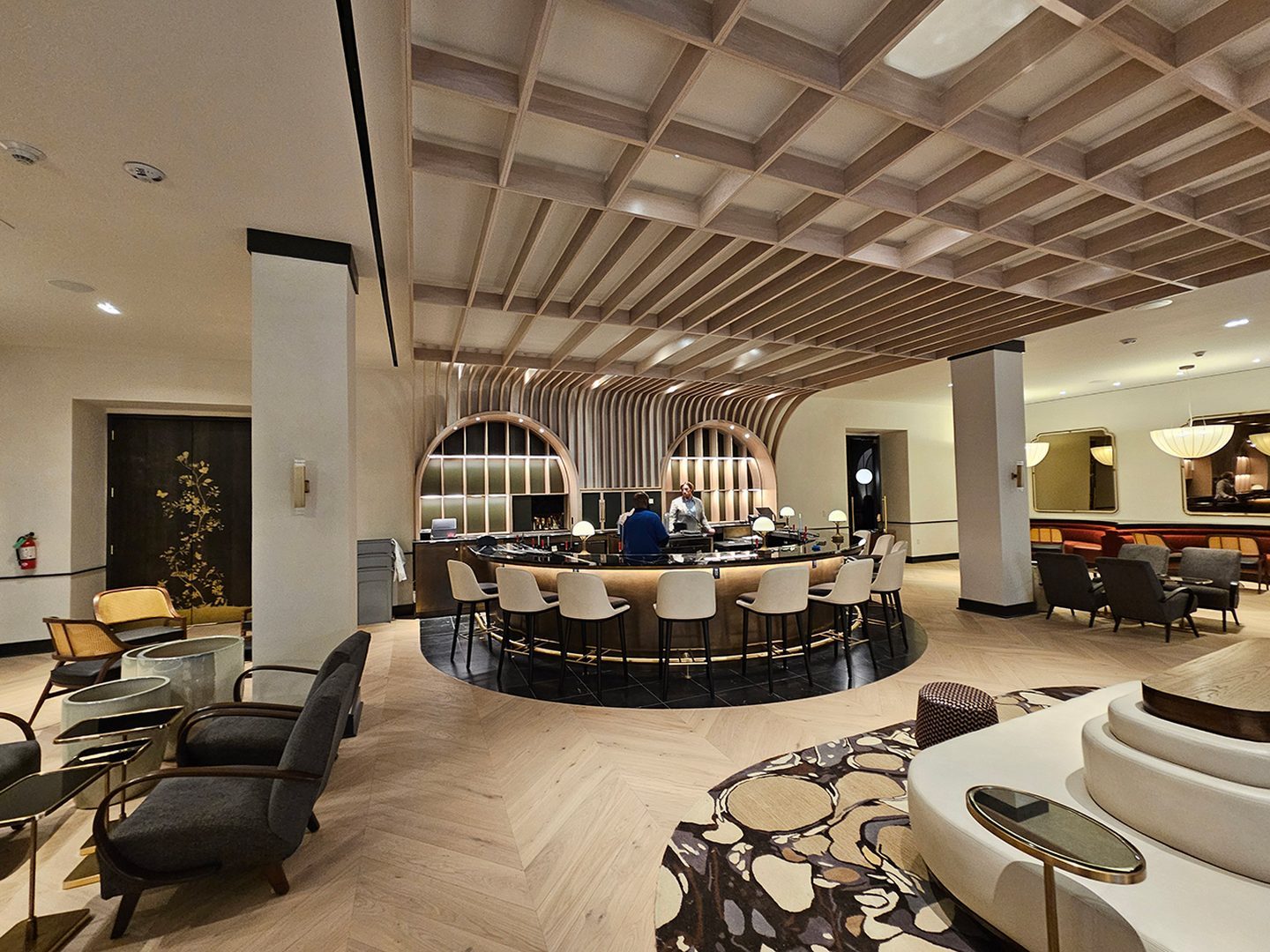 Omni Royal Orleans main bar — curved brass bar with coffered oak ceiling